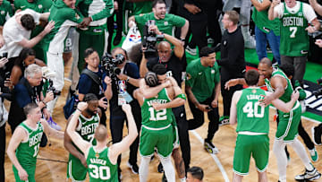Jun 17, 2024; Boston, Massachusetts, USA; Boston Celtics forward Jayson Tatum (0) celebrates with forward Oshae Brissett (12) after defeating the Dallas Mavericks in game five to win the 2024 NBA Finals at TD Garden. Mandatory Credit: David Butler II-Imagn Images