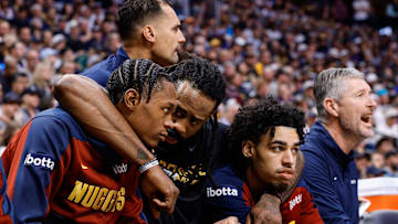 Apr 21, 2025; Denver, Colorado, USA; Denver Nuggets center DeAndre Jordan (6) wraps his arms around forward Peyton Watson (8) and guard Julian Strawther (3) as he talks with them on the bench in the first quarter against the Los Angeles Clippers during game two of first round for the 2025 NBA Playoffs at Ball Arena. Mandatory Credit: Isaiah J. Downing-Imagn Images