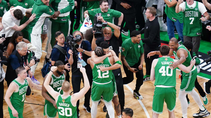 Jun 17, 2024; Boston, Massachusetts, USA; Boston Celtics forward Jayson Tatum (0) celebrates with forward Oshae Brissett (12) after defeating the Dallas Mavericks in game five to win the 2024 NBA Finals at TD Garden. Mandatory Credit: David Butler II-USA TODAY Sports