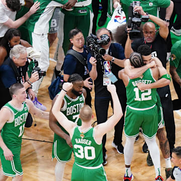 Jun 17, 2024; Boston, Massachusetts, USA; Boston Celtics forward Jayson Tatum (0) celebrates with forward Oshae Brissett (12) after defeating the Dallas Mavericks in game five to win the 2024 NBA Finals at TD Garden. Mandatory Credit: David Butler II-Imagn Images