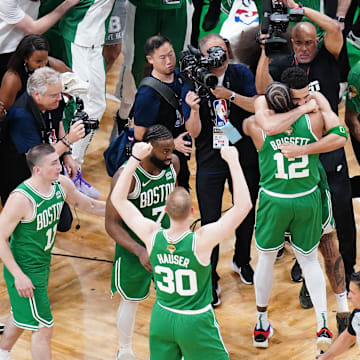 Jun 17, 2024; Boston, Massachusetts, USA; Boston Celtics forward Jayson Tatum (0) celebrates with forward Oshae Brissett (12) after defeating the Dallas Mavericks in game five to win the 2024 NBA Finals at TD Garden. Mandatory Credit: David Butler II-Imagn Images