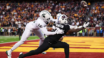 Nov 1, 2025; Minneapolis, Minnesota, USA; Michigan State Spartans defensive back Malcolm Bell (14) commits a pass interference penalty against Minnesota Golden Gophers wide receiver Lemeke Brockington (0) during overtime at Huntington Bank Stadium. Mandatory Credit: Matt Krohn-Imagn Images