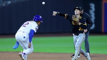 May 14, 2025; New York City, New York, USA; Pittsburgh Pirates second baseman Adam Frazier (26) forces out New York Mets shortstop Francisco Lindor (12) at second then throws to first to complete a double play on a ball hit by third baseman Mark Vientos (not pictured) during the third inning at Citi Field. Mandatory Credit: Brad Penner-Imagn Images