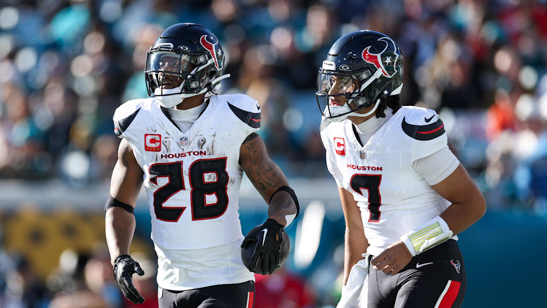 Dec 1, 2024; Jacksonville, Florida, USA; Houston Texans running back Joe Mixon (28) celebrates with quarterback C.J. Stroud (7) after scoring a touchdown  against the Jacksonville Jaguars in the third quarter at EverBank Stadium. Mandatory Credit: Nathan Ray Seebeck-Imagn Images