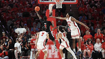Mar 1, 2025; Houston, Texas, USA; Cincinnati Bearcats guard Jizzle James (2) shoots against Houston Cougars forward Joseph Tugler (11) in the first half at Fertitta Center. Mandatory Credit: Thomas Shea-Imagn Images