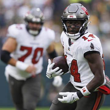 Dec 17, 2023; Green Bay, Wisconsin, USA;  Tampa Bay Buccaneers wide receiver Chris Godwin (14) rushes with the football after catching a pass during the second quarter against the Green Bay Packers at Lambeau Field. 