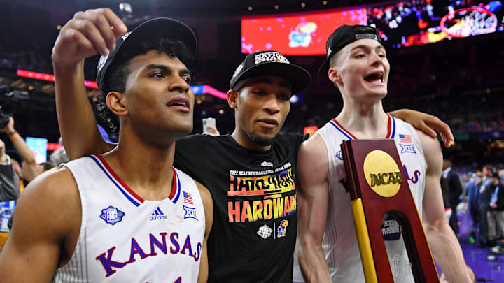 Apr 4, 2022; New Orleans, LA, USA; Kansas Jayhawks guard Remy Martin (left) and guard Dajuan Harris Jr. (center) and guard Christian Braun (right) celebrates their win against the North Carolina Tar Heels in the 2022 NCAA men's basketball tournament Final Four championship game at Caesars Superdome. Mandatory Credit: Bob Donnan-Imagn Images
