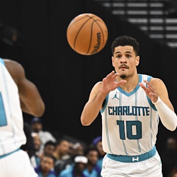 Mar 16, 2025; Inglewood, California, USA; Charlotte Hornets guard Josh Green (10) passes against LA Clippers guard James Harden (1) during the first half at Intuit Dome. Mandatory Credit: Jonathan Hui-Imagn Images