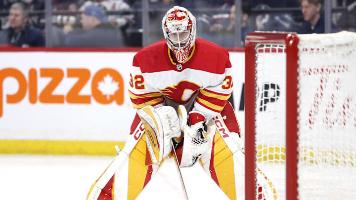 Apr 4, 2024; Winnipeg, Manitoba, CAN; Calgary Flames goaltender Dustin Wolf (32) looks on in the second period against the Winnipeg Jets at Canada Life Centre. Mandatory Credit: James Carey Lauder-Imagn Images