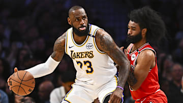 Mar 22, 2025; Los Angeles, California, USA; Los Angeles Lakers forward LeBron James (23) looks to pass against Chicago Bulls guard Coby White (0) during the second half at Crypto.com Arena. Mandatory Credit: Jonathan Hui-Imagn Images