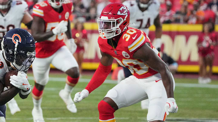 Aug 22, 2024; Kansas City, Missouri, USA; Chicago Bears wide receiver Nsimba Webster (83) runs the ball as Kansas City Chiefs cornerback Christian Roland-Wallace (30) defends during the first half at GEHA Field at Arrowhead Stadium. Mandatory Credit: Denny Medley-Imagn Images