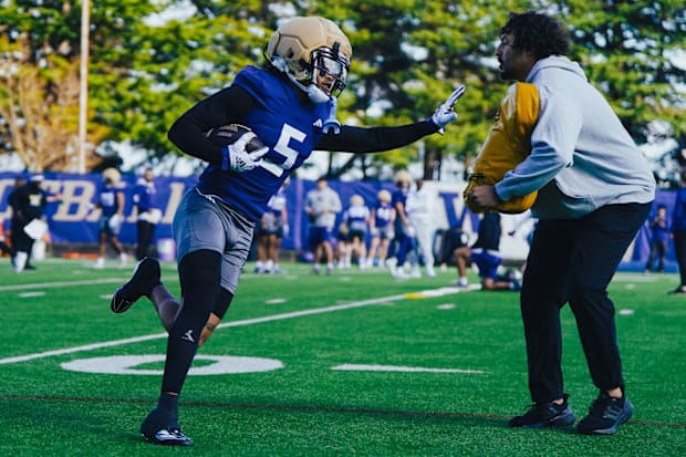 Omari Evans stiff-arms a coach during spring receivers drill. 