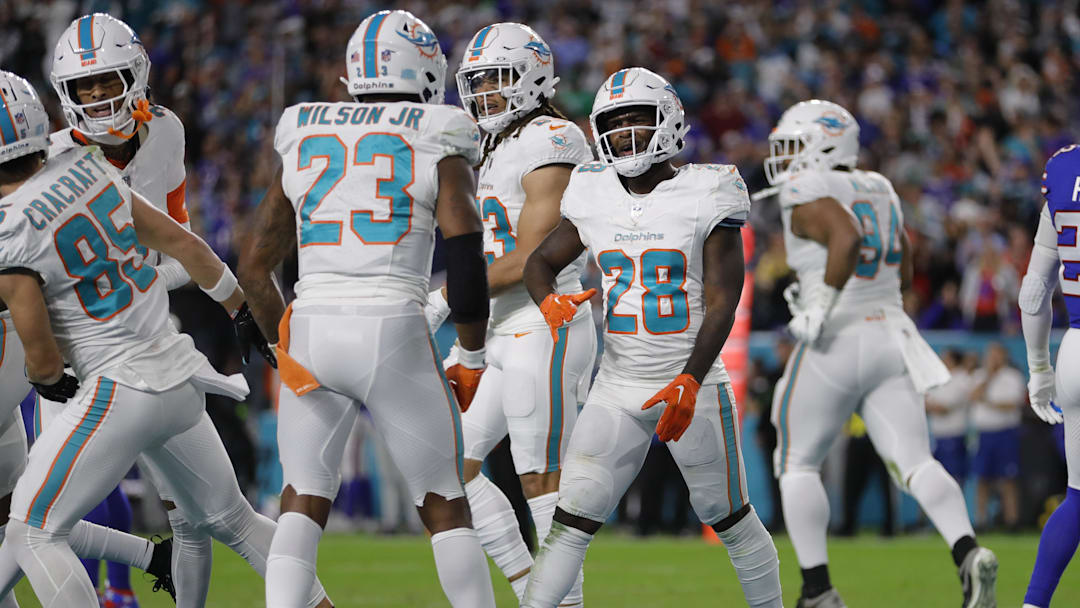 Jan 7, 2024; Miami Gardens, Florida, USA; Miami Dolphins running back De'Von Achane (28) celebrates with teammates after scoring a touchdown against the Buffalo Bills during the second quarter at Hard Rock Stadium. Mandatory Credit: Sam Navarro-Imagn Images