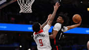Feb 26, 2025; Washington, District of Columbia, USA; Portland Trail Blazers guard Shaedon Sharpe (17) dunks the ball over Washington Wizards forward Justin Champagnie (9) in the first half at Capital One Arena. Mandatory Credit: Geoff Burke-Imagn Images