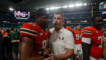 Sep 13, 2025; Miami Gardens, Florida, USA; Miami Hurricanes head coach Mario Cristobal celebrates with defensive lineman Ahmad Moten Sr. (99) after the game against the South Florida Bulls at Hard Rock Stadium. Mandatory Credit: Sam Navarro-Imagn Images