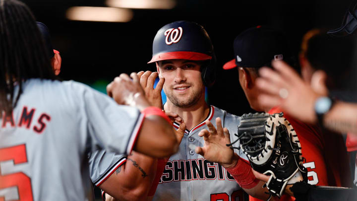 Jun 21, 2024; Denver, Colorado, USA; Washington Nationals right fielder Lane Thomas (28) celebrates in the dugout after scoring on an RBI in the fourth inning against the Colorado Rockies at Coors Field. Mandatory Credit: Isaiah J. Downing-USA TODAY Sports