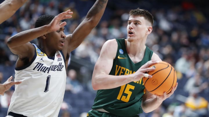 Mar 17, 2023; Columbus, OH, USA; Vermont Catamounts guard Finn Sullivan (15) controls the ball defended by Marquette Golden Eagles guard Kam Jones (1) at Nationwide Arena. Mandatory Credit: Joseph Maiorana-USA TODAY Sports