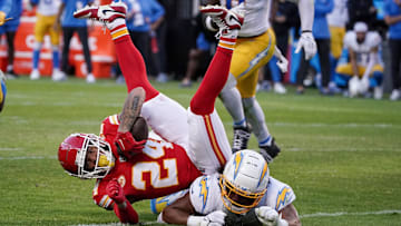 Kansas City Chiefs wide receiver Skyy Moore (24) runs the ball as Los Angeles Chargers linebacker Kenneth Murray Jr. (9) makes the tackle during the second half at GEHA Field at Arrowhead Stadium.