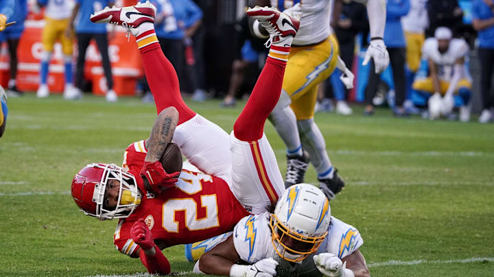 Kansas City Chiefs wide receiver Skyy Moore (24) runs the ball as Los Angeles Chargers linebacker Kenneth Murray Jr. (9) makes the tackle during the second half at GEHA Field at Arrowhead Stadium.