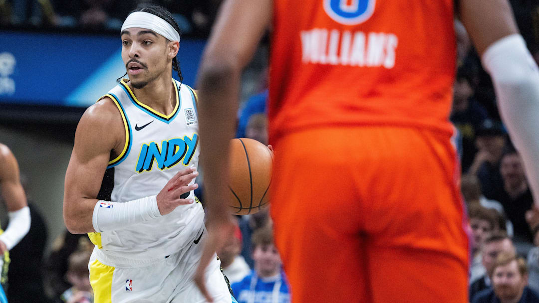 Dec 26, 2024; Indianapolis, Indiana, USA; Indiana Pacers guard Andrew Nembhard (2) dribbles the ball while Oklahoma City Thunder forward Jalen Williams (8) defends in the first half at Gainbridge Fieldhouse. Mandatory Credit: Trevor Ruszkowski-Imagn Images