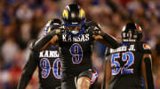 Kansas redshirt sophomore defensive lineman Austin Booker (9) reacts after a sack in the fourth quarter of Saturday's Sunflower Showdown against Kansas State inside David Booth Kansas Memorial Stadium.