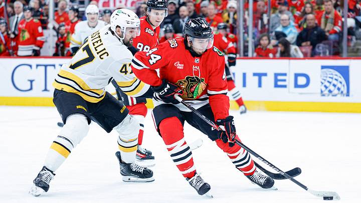 Jan 17, 2026; Chicago, Illinois, USA; Chicago Blackhawks defenseman Wyatt Kaiser (44) is defended by Boston Bruins center Mark Kastelic (47) during the first period at United Center. Mandatory Credit: Kamil Krzaczynski-Imagn Images Jan 17, 2026; Chicago, Illinois, USA; Chicago Blackhawks defenseman Wyatt Kaiser (44) is defended by Boston Bruins center Mark Kastelic (47) during the first period at United Center. Mandatory Credit: Kamil Krzaczynski-Imagn Images