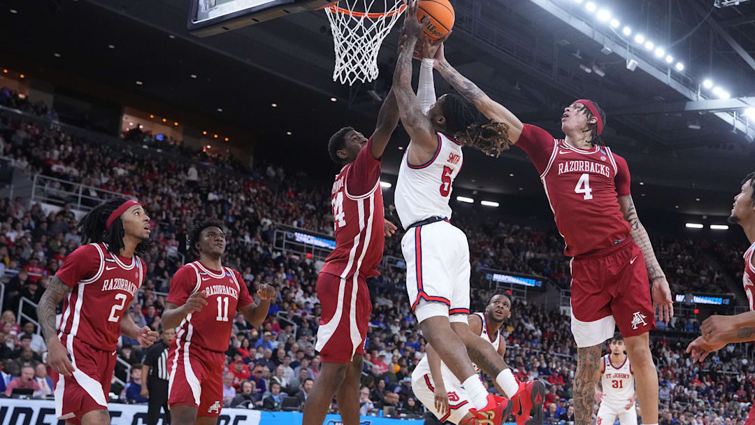 Mar 22, 2025; Providence, RI, USA; St. John's Red Storm guard Deivon Smith (5) shoots against Arkansas Razorbacks forward Trevon Brazile (4) and forward Billy Richmond III (24) during the first half of a second round men’s NCAA Tournament game at Amica Mutual Pavilion. Mandatory Credit: Gregory Fisher-Imagn Images