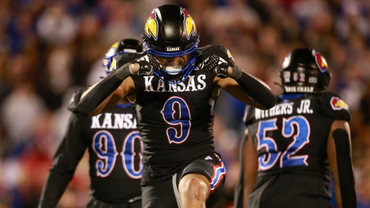 Kansas redshirt sophomore defensive lineman Austin Booker (9) reacts after a sack in the fourth quarter of Saturday's Sunflower Showdown against Kansas State inside David Booth Kansas Memorial Stadium.