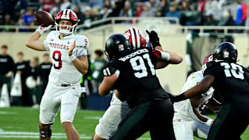 Nov 2, 2024; East Lansing, Michigan, USA;  Indiana Hoosiers quarterback Kurtis Rourke (9) looks for a receiver during the fourth quarter against the Michigan State Spartans at Spartan Stadium. Mandatory Credit: Dale Young-Imagn Images