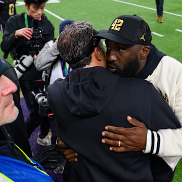 Nov 15, 2024; Seattle, Washington, USA; Washington Huskies head coach Jedd Fisch and UCLA Bruins head coach DeShaun Foster greet each other after the game at Alaska Airlines Field at Husky Stadium. Mandatory Credit: Steven Bisig-Imagn Images