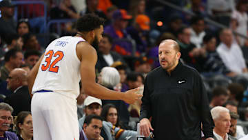 Nov 20, 2024; Phoenix, Arizona, USA; New York Knicks head coach Tom Thibodeau with center Karl-Anthony Towns (32) against the Phoenix Suns at Footprint Center. Mandatory Credit: Mark J. Rebilas-Imagn Images