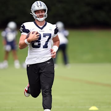 Jun 4, 2024; Frisco, TX, USA;  Dallas Cowboys tight end Jake Ferguson (87) goes through a drill during practice at the Ford Center at the Star Training Facility in Frisco, Texas.