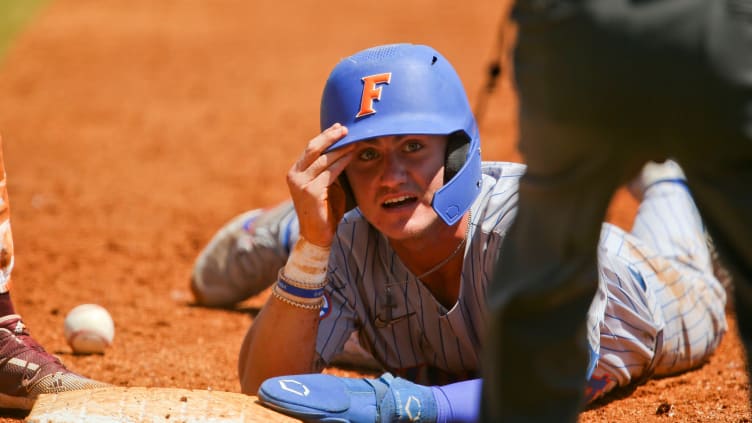 Florida base runner Jud Fabian (4) looks up to the umpire after being called safe.