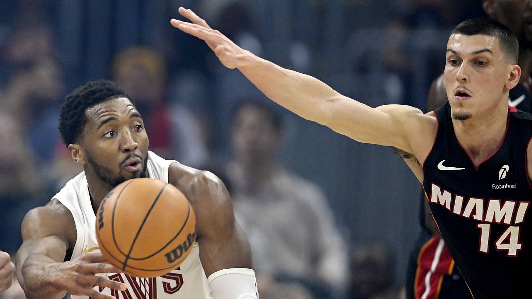 Mar 25, 2026; Cleveland, Ohio, USA; Cleveland Cavaliers guard Donovan Mitchell (45) passes the ball beside Miami Heat guard Tyler Herro (14) in the first quarter at Rocket Arena. Mandatory Credit: David Richard-Imagn Images