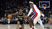 Dec 9, 2022; Memphis, Tennessee, USA; Memphis Grizzlies guard Ja Morant (12) dribbles as Detroit Pistons center Jalen Duren (0) defends during the second half at FedExForum. Mandatory Credit: Petre Thomas-Imagn Images