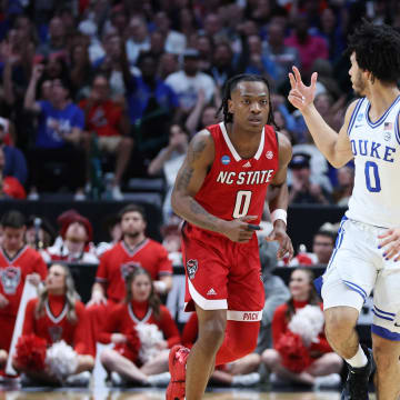 Mar 31, 2024; Dallas, TX, USA; Duke Blue Devils guard Jared McCain (0) and North Carolina State Wolfpack guard DJ Horne (0) react in the first half in the finals of the South Regional of the 2024 NCAA Tournament at American Airline Center. Mandatory Credit: Tim Heitman-USA TODAY Sports