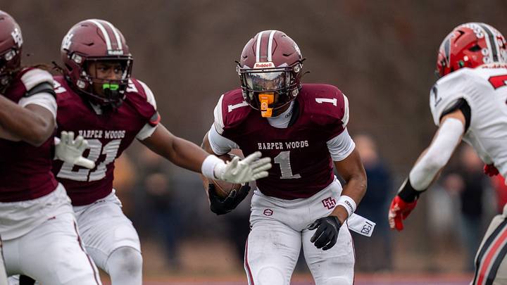 Harper Woods wide receiver Dakota Guerrant (1) runs the ball against the Divine Child High School defense during a Division 4 regional final at John Glenn High School in Westland on Saturday, Nov. 15, 2025.