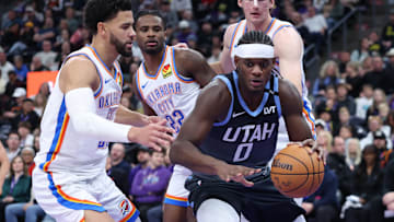 Dec 7, 2025; Salt Lake City, Utah, USA; Utah Jazz forward Taylor Hendricks (0) goes to the basket against Oklahoma City Thunder guard Ajay Mitchell (left), guard Cason Wallace (22) and center Branden Carlson (back) during the second half at Delta Center. Mandatory Credit: Rob Gray-Imagn Images