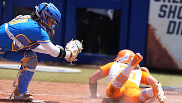 Tennessee's McKenna Gibson (24) slides into home for a score as UCLA's Alexis Ramirez (28) tries to place the tag in the first inning of the Women's College World Series softball game between the UCLA Bruins and the Tennessee Volunteers at Devon Park in Oklahoma City, Sunday, June, 1, 2025.