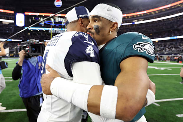 Dallas Cowboys quarterback Dak Prescott hugs Philadelphia Eagles quarterback Jalen Hurts after the game at AT&T Stadium.