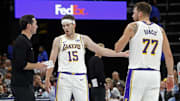 Oct 31, 2025; Memphis, Tennessee, USA; Los Angeles Lakers head coach JJ Redick talks with guard Austin Reaves (15) and guard Luka Doncic (77) during the fourth quarter against the Memphis Grizzlies at FedExForum. Mandatory Credit: Petre Thomas-Imagn Images