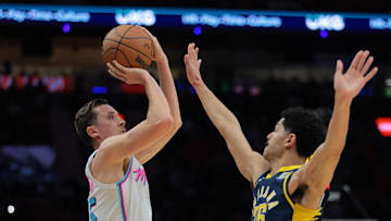 Feb 28, 2025; Miami, Florida, USA; Miami Heat forward Duncan Robinson (55) shoots the basketball over Indiana Pacers guard Ben Sheppard (26) during the fourth quarter at Kaseya Center. Mandatory Credit: Sam Navarro-Imagn Images