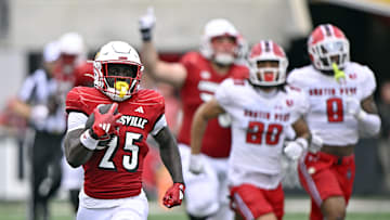Aug 31, 2024; Louisville, Kentucky, USA;  Louisville Cardinals running back Isaac Brown (25) runs the ball against the Austin Peay Governors during the second half at L&N Federal Credit Union Stadium. Louisville defeated Austin Peay 62-0. Mandatory Credit: Jamie Rhodes-Imagn Images