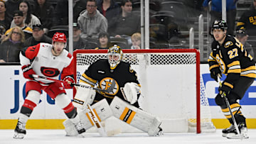 Nov 1, 2025; Boston, Massachusetts, USA; Carolina Hurricanes left wing Taylor Hall (71), Boston Bruins goaltender Jeremy Swayman (1) and defenseman Hampus Lindholm (27) watch the loose puck during the third period at TD Garden. Mandatory Credit: Eric Canha-Imagn Images