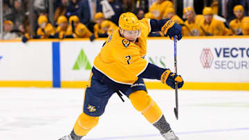 Jan 21, 2025; Nashville, Tennessee, USA;  Nashville Predators defenseman Luke Schenn (2) takes a shot on goal against the San Jose Sharks during the first period at Bridgestone Arena. Mandatory Credit: Steve Roberts-Imagn Images