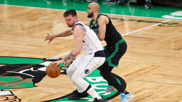 June 9, 2024;  Boston, Massachusetts, USA;  Dallas Mavericks guard Luka Doncic (77) controls the ball against Boston Celtics center Al Horford (42) in the fourth quarter of Game 2 of the 2024 NBA Finals at TD Garden.  Mandatory Credit: Peter Casey – USA TODAY Sports