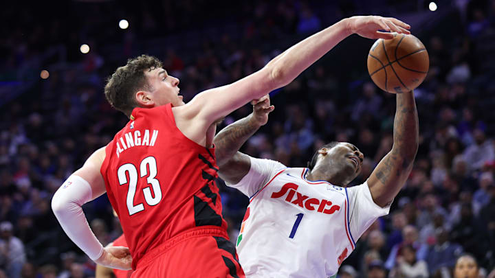 Mar 3, 2025; Philadelphia, Pennsylvania, USA; Portland Trail Blazers center Donovan Clingan (23) blocks the drive of Philadelphia 76ers center Andre Drummond (1) during the second quarter at Wells Fargo Center. Mandatory Credit: Bill Streicher-Imagn Images