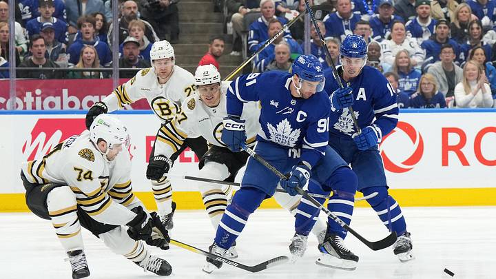Apr 27, 2024; Toronto, Ontario, CAN; Toronto Maple Leafs center John Tavares (91) battles for the puck with Boston Bruins left wing Jake DeBrusk (74) during the first period in game four of the first round of the 2024 Stanley Cup Playoffs at Scotiabank Arena. Mandatory Credit: Nick Turchiaro-USA TODAY Sports