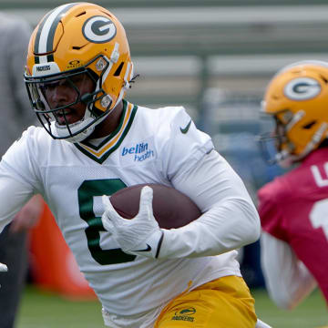 Green Bay Packers running back Josh Jacobs (8) carries the ball during minicamp. 