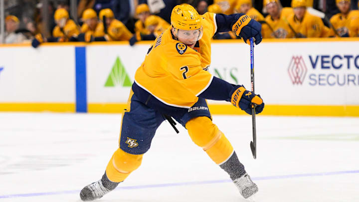 Jan 21, 2025; Nashville, Tennessee, USA;  Nashville Predators defenseman Luke Schenn (2) takes a shot on goal against the San Jose Sharks during the first period at Bridgestone Arena. Mandatory Credit: Steve Roberts-Imagn Images